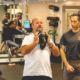 Coach guiding athlete through kettlebell lift during personal training at Sherpa in Westport, CT