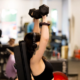 Woman lifting dumbbells during personal training workout at Sherpa in Westport CT