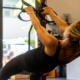 Woman performing suspension trainer pull-ups using bodyweight training straps at Sherpa fitness studio in Westport CT