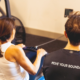 Rower training with Sherpa coach in Westport, CT wearing Move Your Boundaries shirt during September rowing challenge.