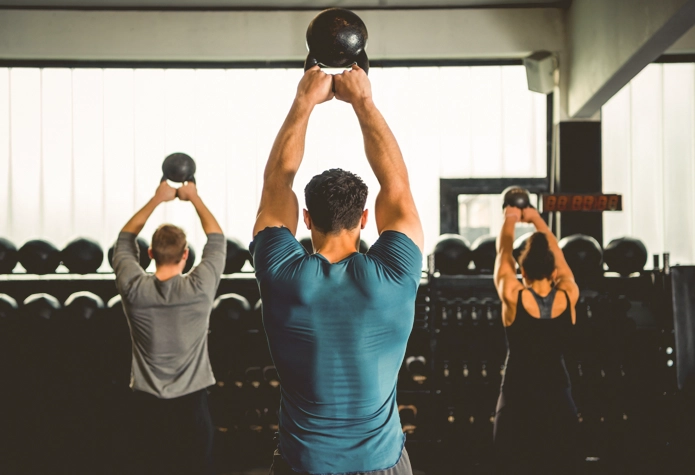 Small group of clients lifting kettlebells together during Sherpa small group personal training in Westport CT