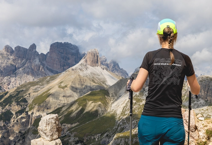 Woman hiking in the Dolomites wearing a Sherpa t-shirt, representing expedition-ready training from Westport, CT.