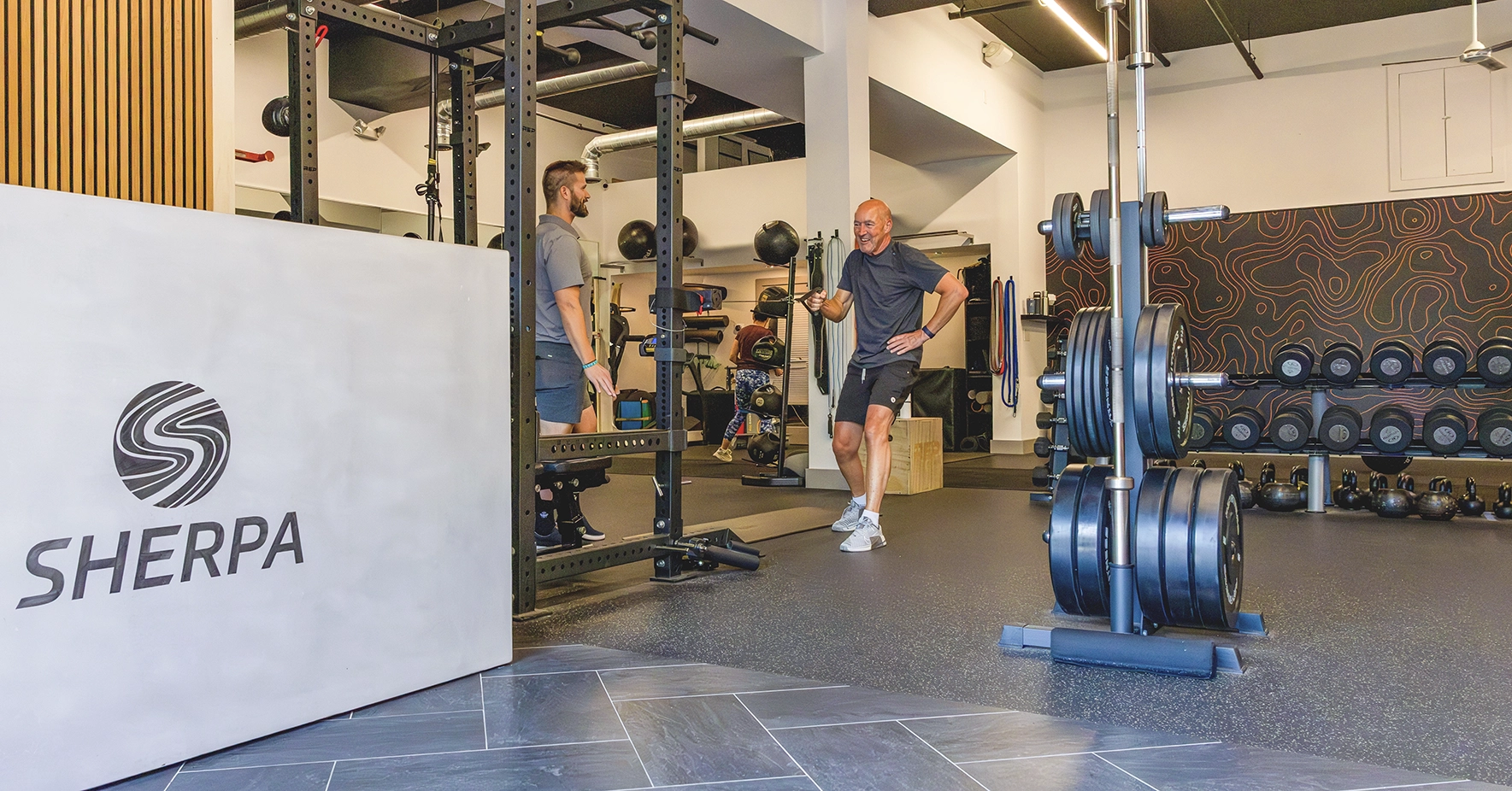 Coach guiding an active adult through strength training at Sherpa in Westport, CT.